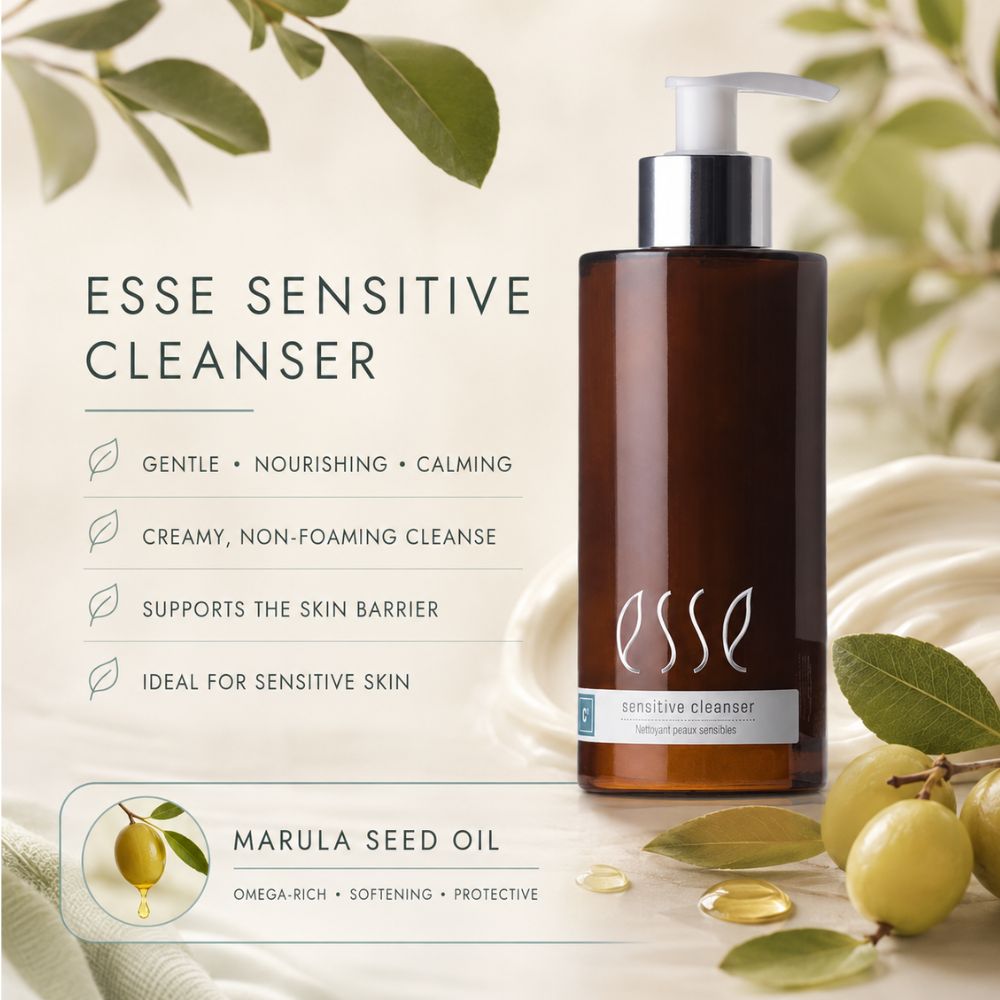 Essé Sensitive Cleanser in a dark amber bottle with a white pump, displayed alongside marketing text and marula seed oil illustrations on a soft beige background with green leaves.