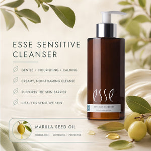 Essé Sensitive Cleanser in a dark amber bottle with a white pump, displayed alongside marketing text and marula seed oil illustrations on a soft beige background with green leaves.