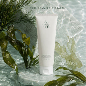 A white tube of Angelto face and Body Barrier Repair Cream stands upright in clear water with seaweed leaves around it. Text at the top reads 'FOUR SEAWEED EXTRACTS'.