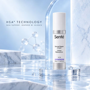 Sente Dermal Repair Cream in a white cylindrical bottle with a silver cap, displayed on a clear acrylic pedestal in a clean, icy blue studio setting with water and marble textures.
