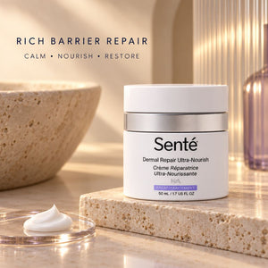 Sente Dermal Repair Ultra-Nourish cream jar on a stone slab with a dollop of white cream in a glass dish, set in a warm, sunlit bathroom-like setting with a bowl and bottle in the background.
