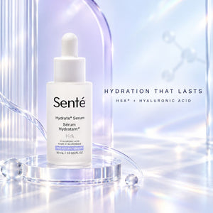 Sente Hydrate+Serum in a white dropper bottle, displayed on a clear acrylic pedestal with a soft, glowing blue and purple background and text reading 'HYDRATION THAT LASTS'.