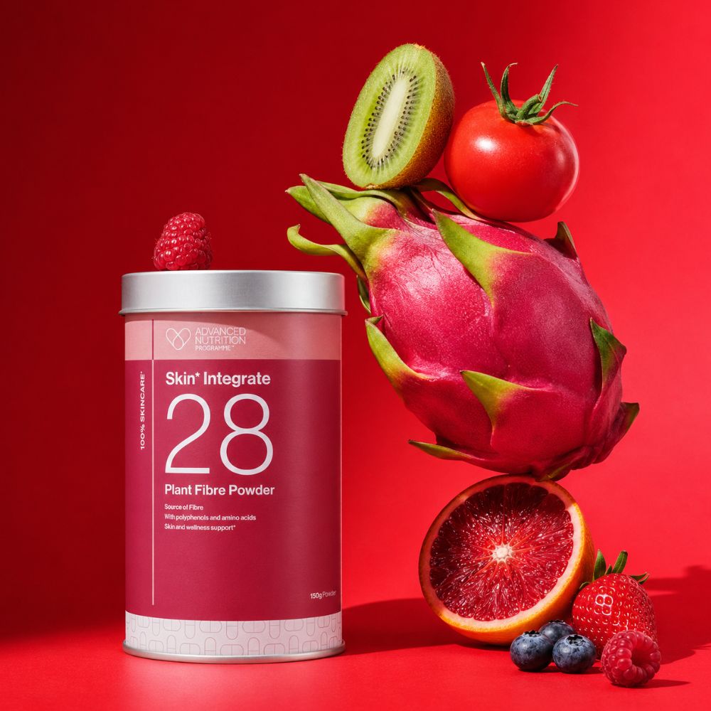 A 1000g canister of Skin'Integrate 28 Plant Fibre Powder by Pure Encapsulations, styled with fresh fruits (dragon fruit, kiwi, blood orange, strawberries, blueberries, and a tomato) on a vibrant red background.