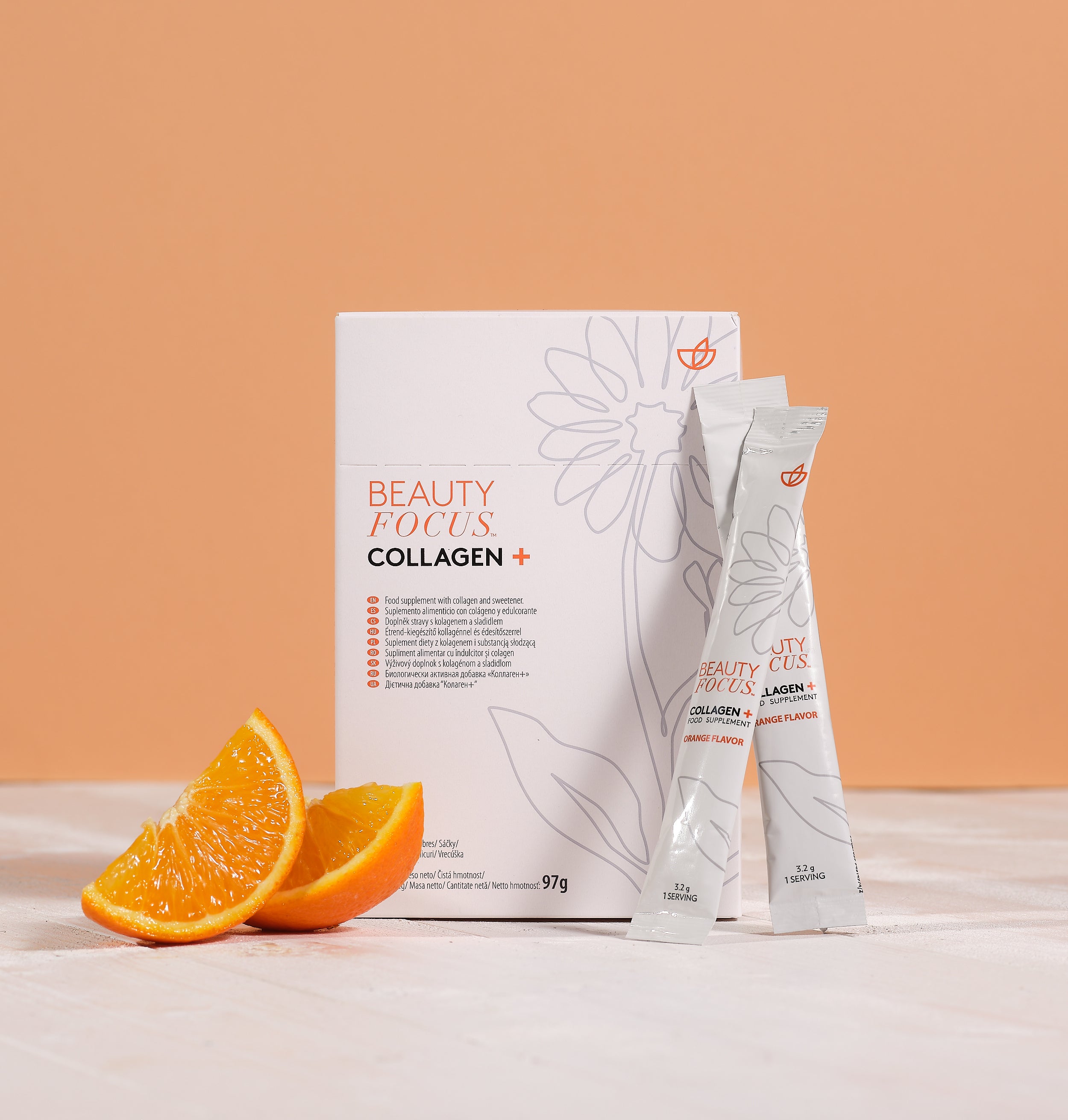 Beauty Focus Collagen packaging with two sachets and orange slices on a peach background
