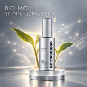 Dermalogica Futurecode Booster serum bottle in silver, displayed on a metallic pedestal with glowing light effects, digital circuit graphics, and green plant leaves in the background under the text 'BIOHACK SKIN'S LONGEVITY'.