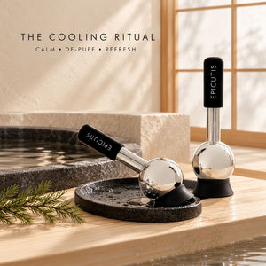 Two  Epicutis Cryo Globes cooling massage devices displayed on a wooden surface beside a stone basin, with text reading 'THE COOLING RITUAL' in a warm spa-like setting.