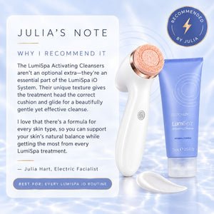 LumiSpa Activating Cleansers set featuring a white and rose gold facial cleansing device, a blue squeeze tube of Activating Cleanser, a cotton pad, and a white informational card with a blue 'Recommended by Julia' badge on a light blue water-textured background.