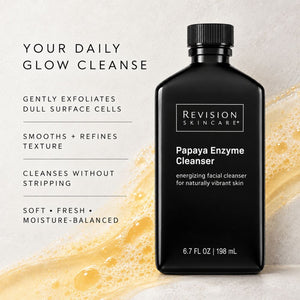 A black bottle of Revision Skincare Papaya Enzyme Cleanser stands on a light textured surface with golden cleanser splash graphics and marketing text on the left.