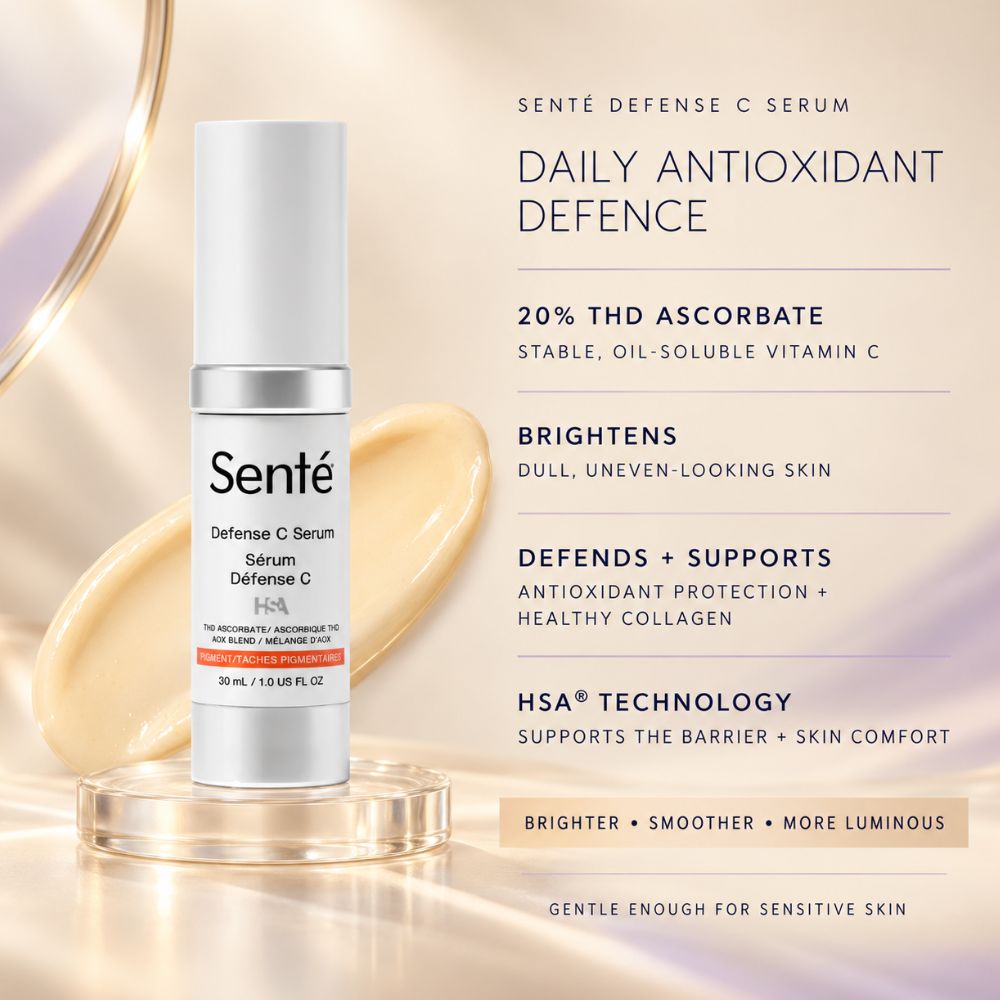 Sente Defense C Serum bottle displayed on a clear acrylic stand against a warm beige background with gold abstract curves and product text callouts.